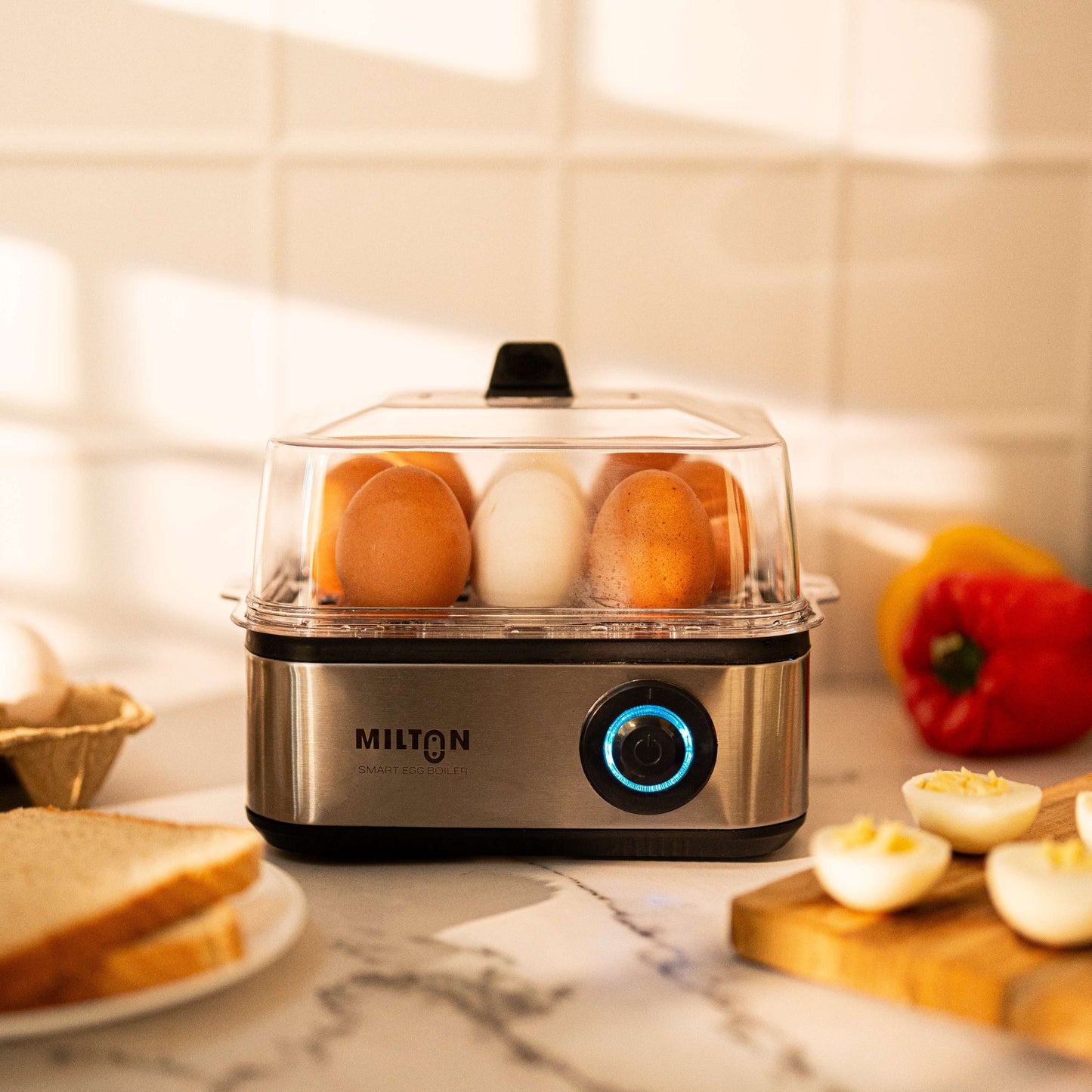 Milton Smart 8 Egg Boiler with transparent lid and stainless steel heating plate.