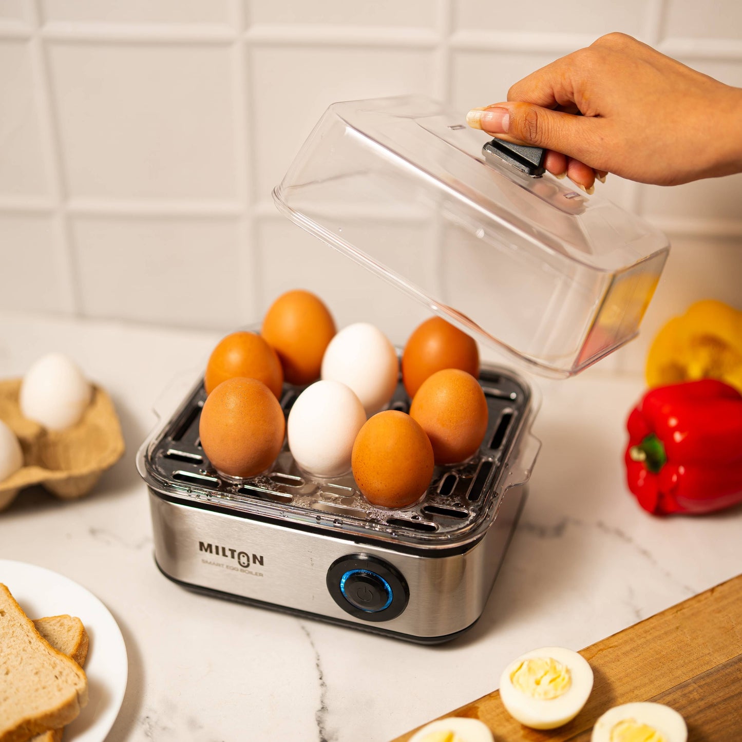 Milton Smart 8 Egg Boiler with transparent lid and stainless steel heating plate.