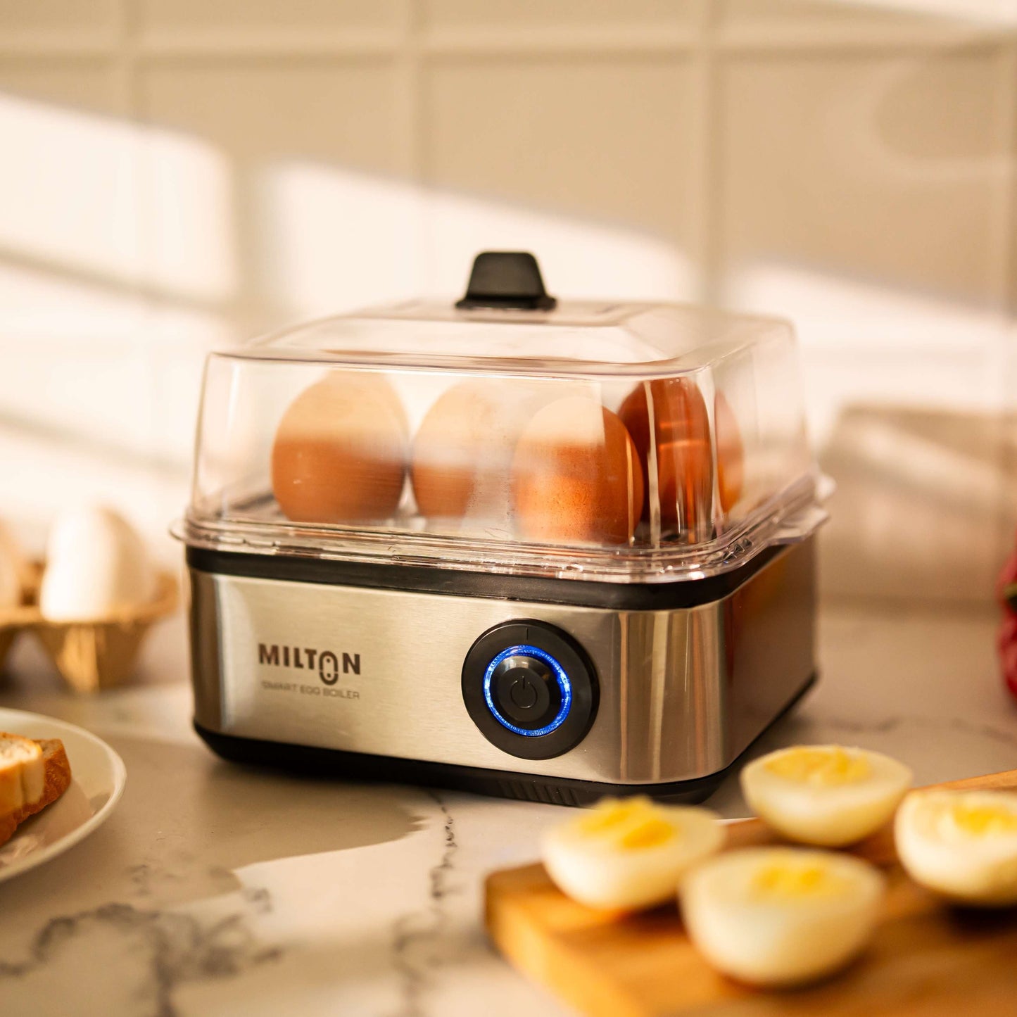Milton Smart 8 Egg Boiler with transparent lid and stainless steel heating plate.