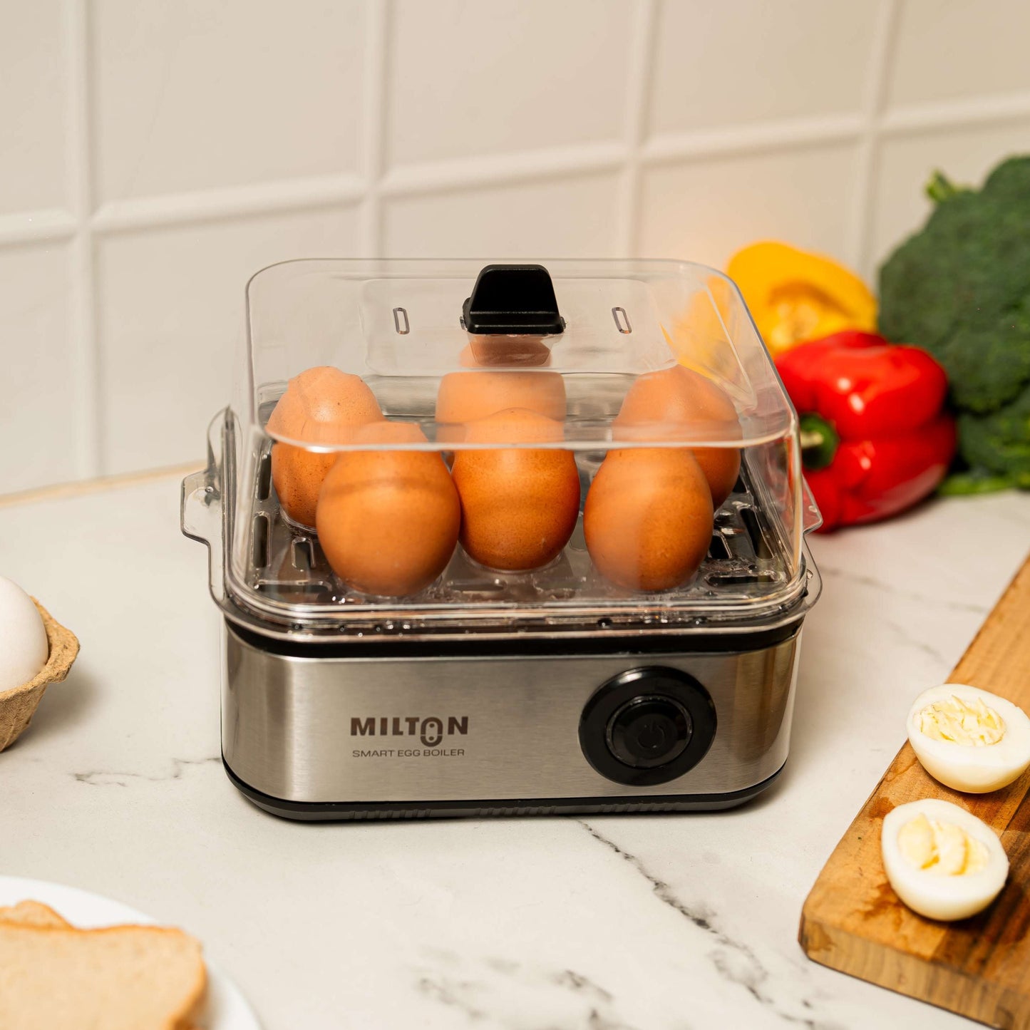 Milton Smart 8 Egg Boiler with transparent lid and stainless steel heating plate.